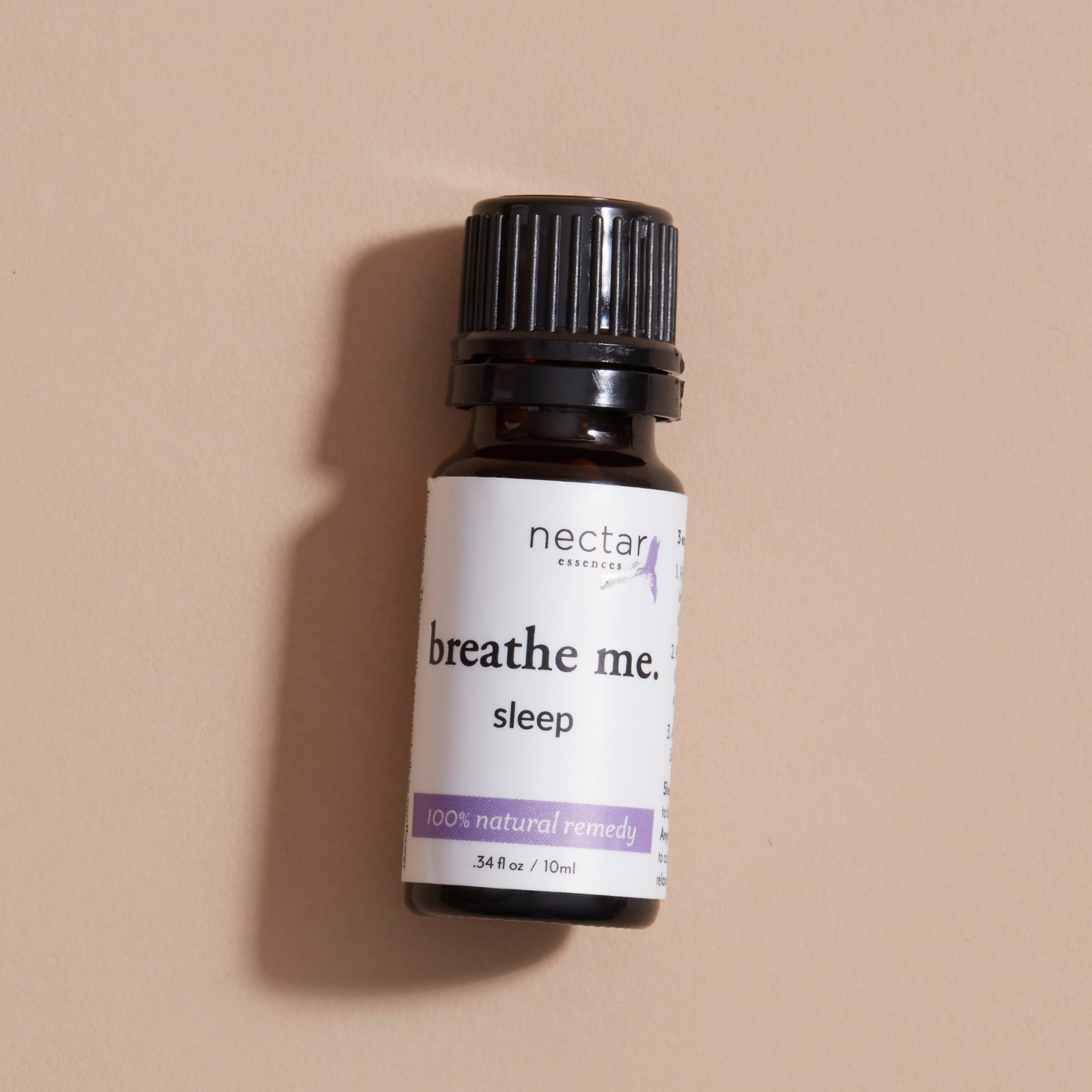 Bottle of 'breathe me. sleep' by nectar laying on a beige background