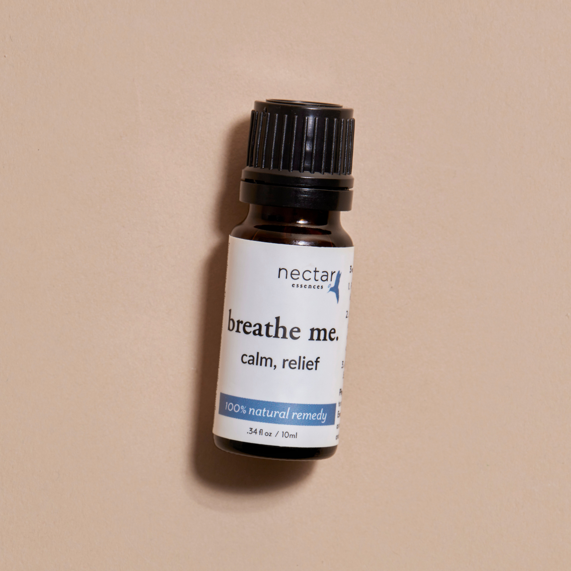 Bottle of 'breathe me' product calm relief remedy by nectar on a beige background