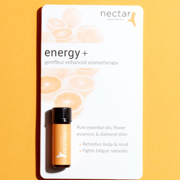 Product card for 'energy+ gemfleur enhanced aromatherapy.' Features a teal-labeled oil bottle and text listing benefits: body & mind refresh, fight fatigue