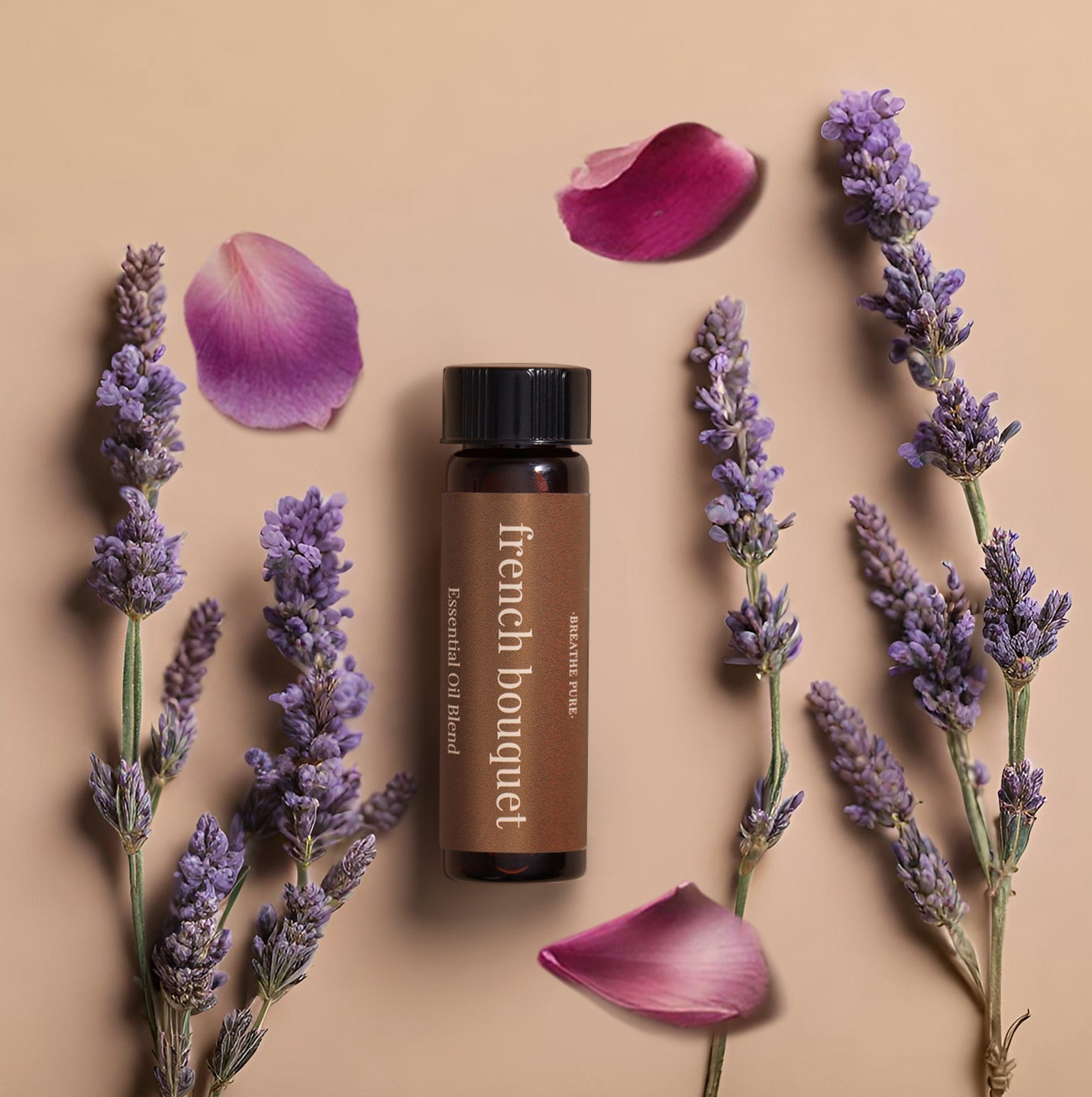 A bottle labeled 'French Bouquet' with a dropper, surrounded by purple flowers and a few scattered pink roses on a beige background.