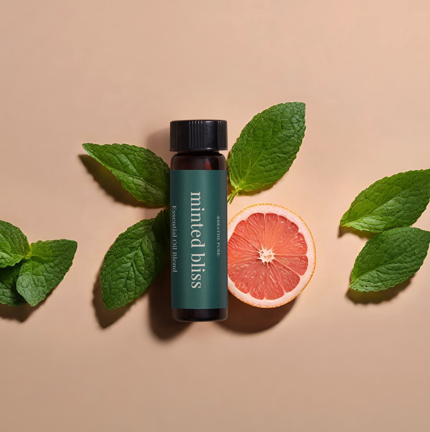 Minted Bliss essential oil bottle next to a beige aromatherapy diffuser emitting steam, styled with fresh grapefruit and mint leaves.