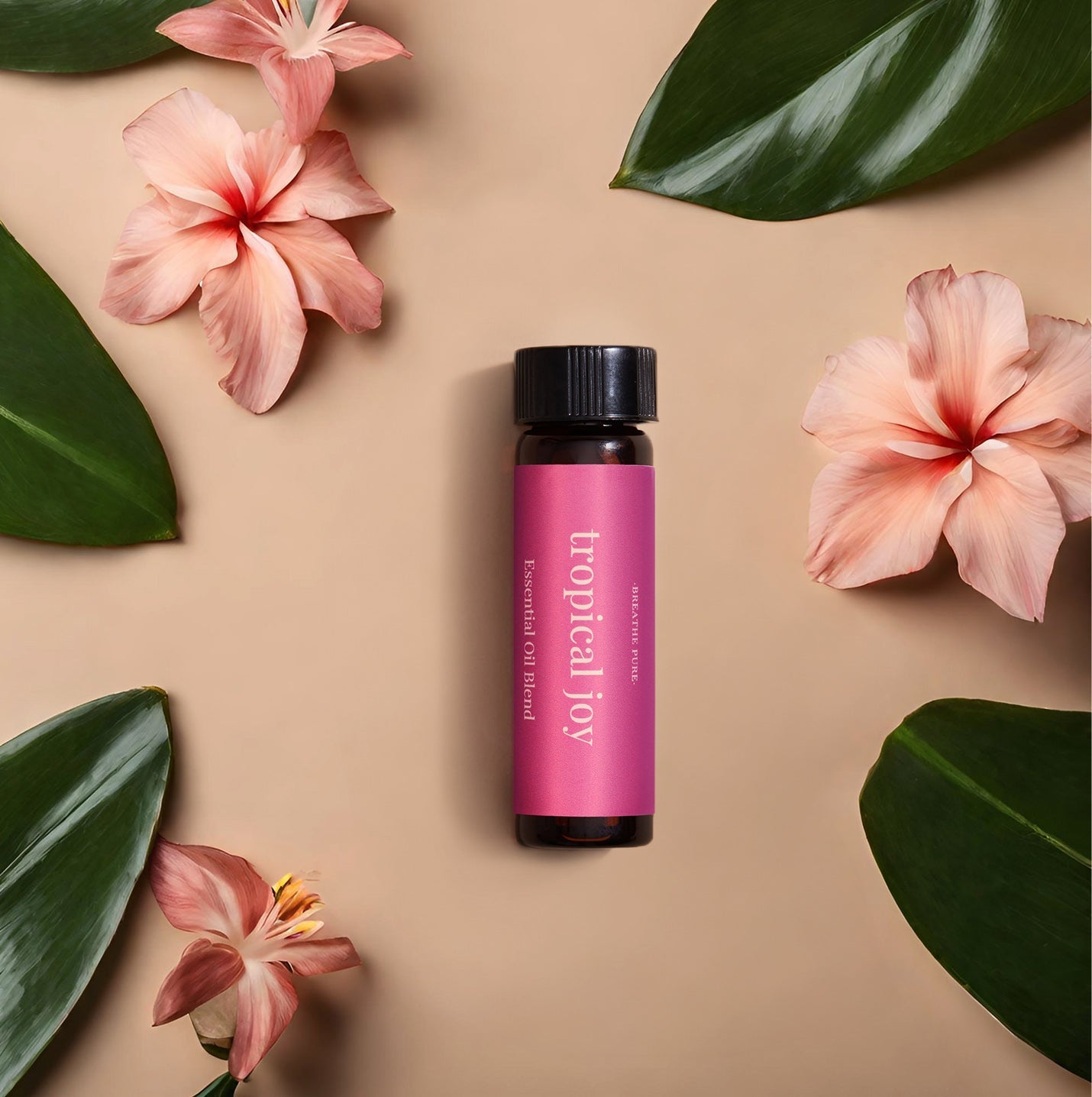 Tropical Joy essential oil blend bottle flat lay styled with pink hibiscus flowers and lush green leaves.