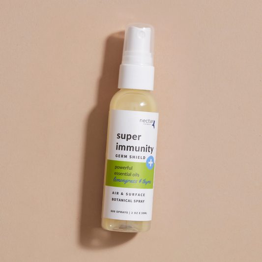 Super Immunity Germ Shield air and surface botanical spray bottle laying on a beige background